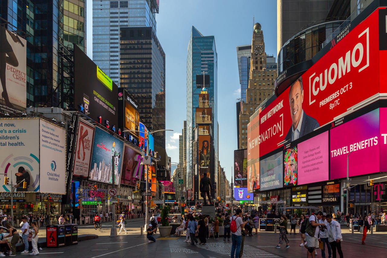 Captured on a sunny day, Times Square buzzes with urban energy and colorful billboards.
